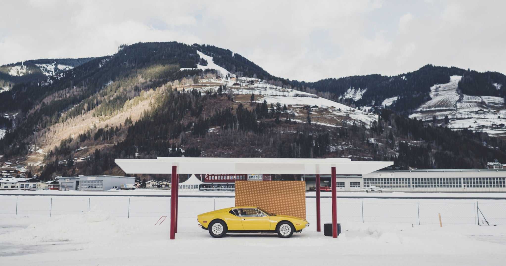 <span>A vintage yellow De Tomaso Pantera is displayed in a portable pavilion designed by Ferdi’s firm, Steiner Architecture, for the 2022 GP Ice Race</span> <br/><span class="caption-sub"><em>Photo credit: Amy Shore </em></span><br/>